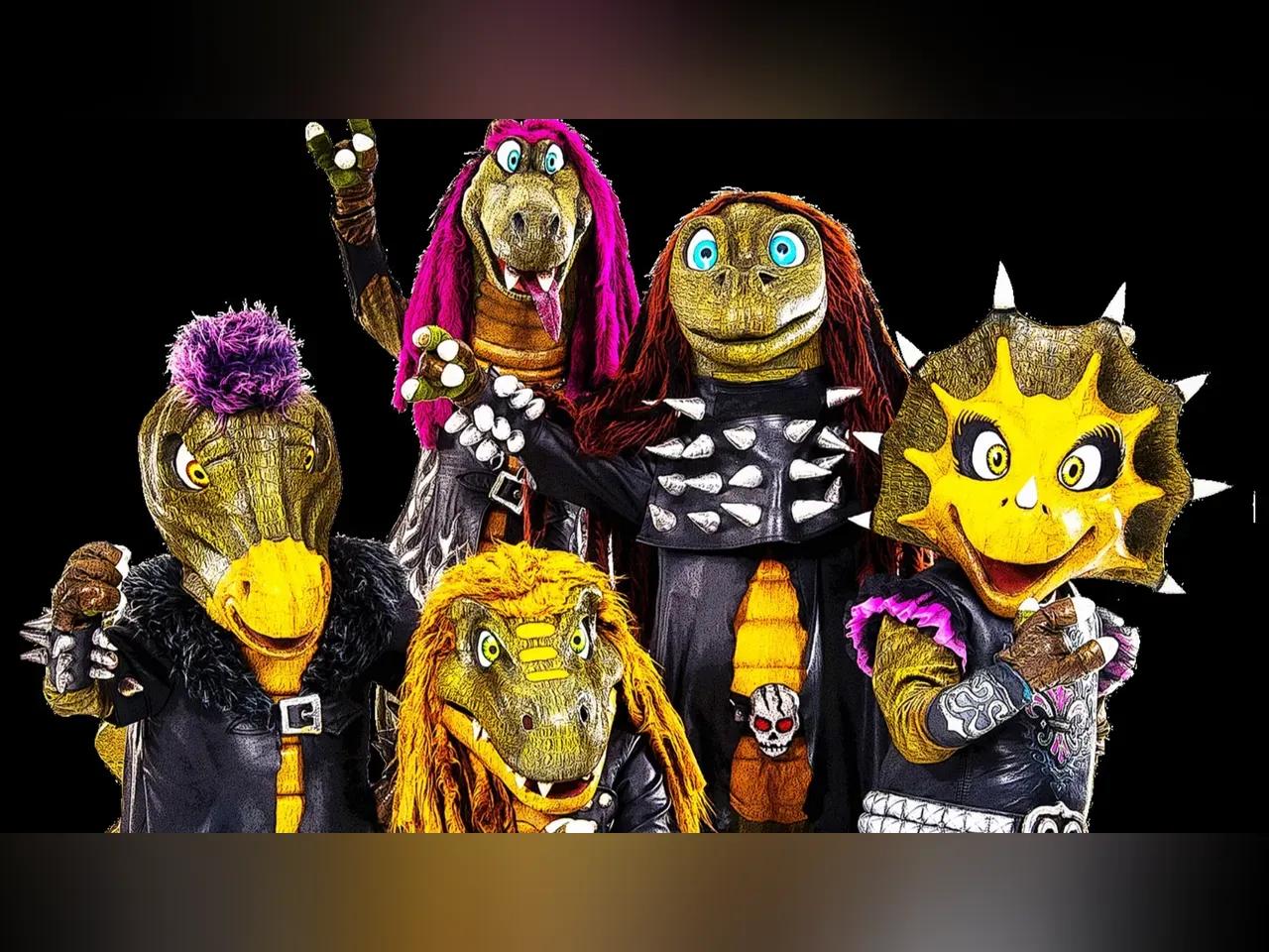 Vier Dinosaurier und ein Drache in rockigen Outfits