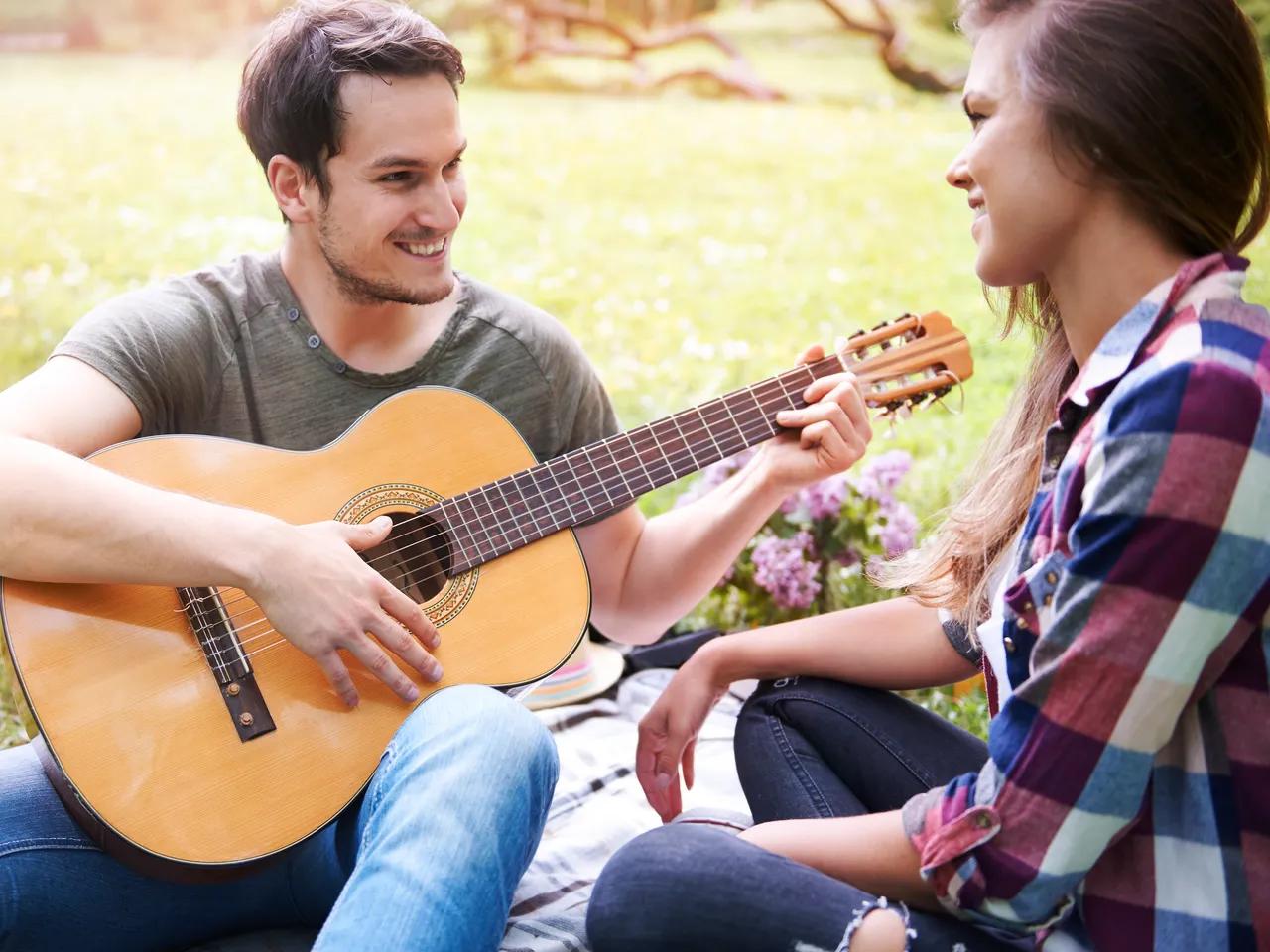 couple-enjoying-picnic-park-man-playing-guitar-romantic-date