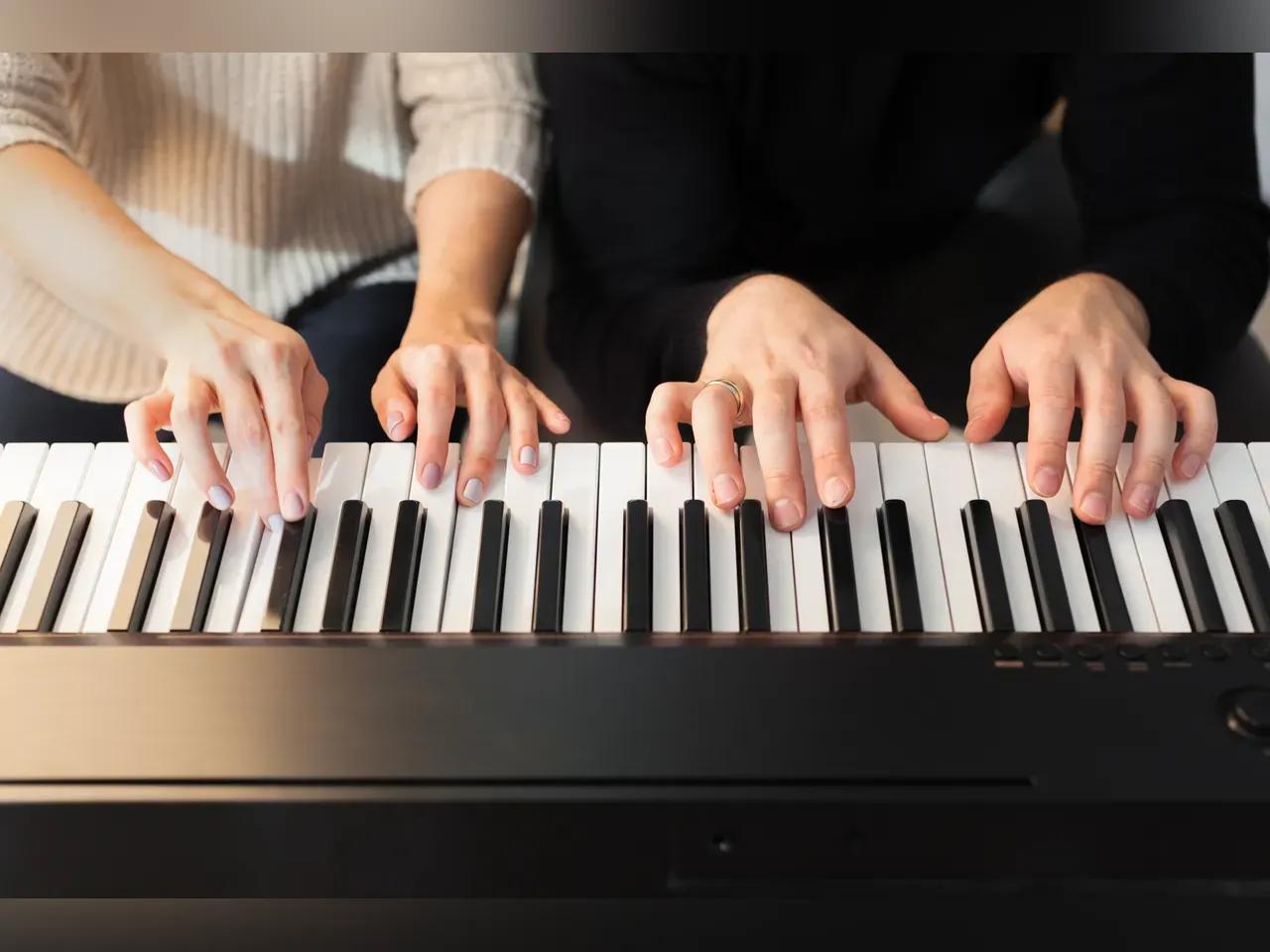 Closeup of hands playing piano. Music and hobby concept