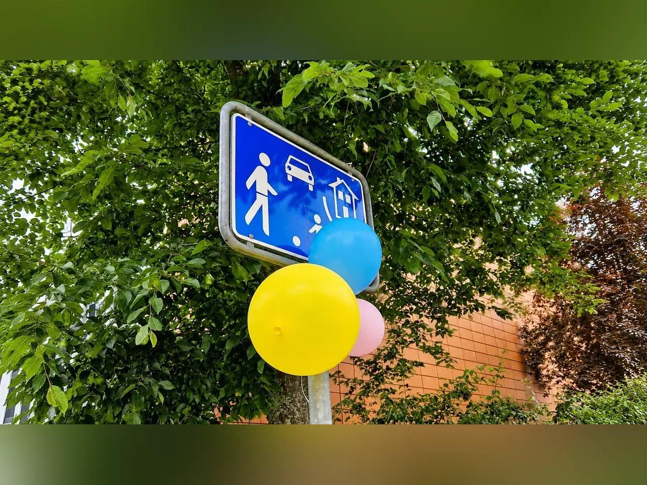 Spielstraßenschild mit Luftballons