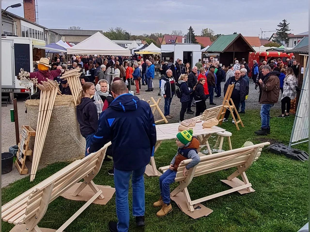 Menschen an einem Stand mit Holzhandwerk